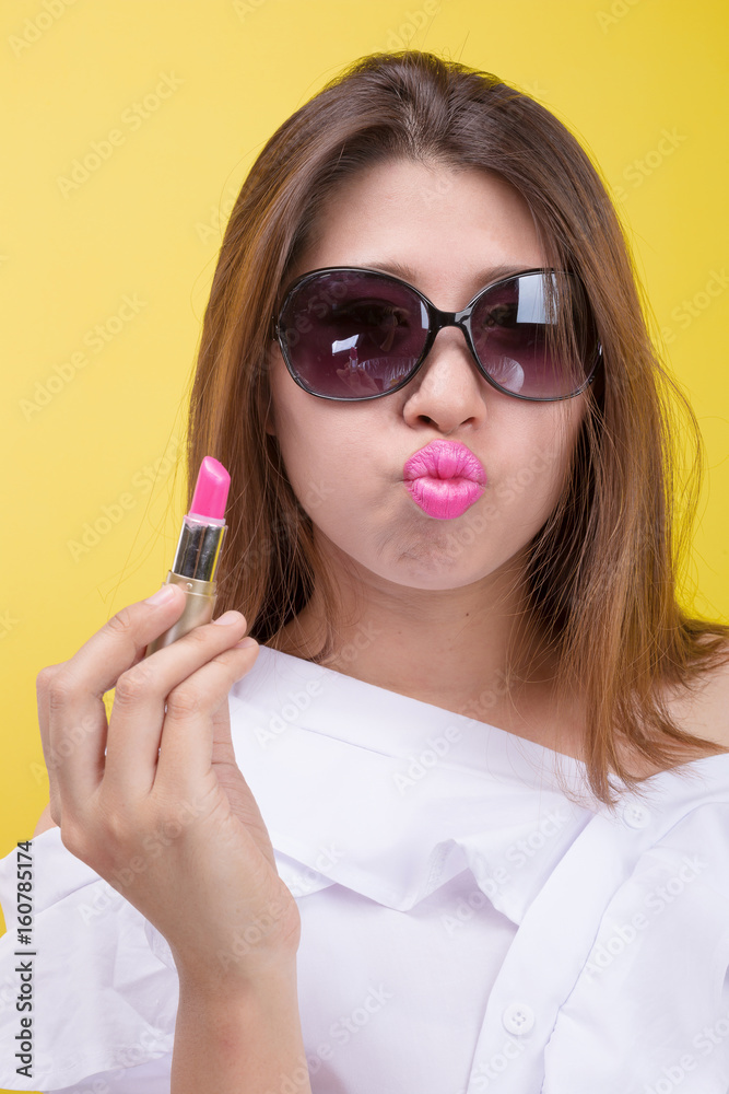 Gorgeous woman applying pink lipstick. Gorgeous woman applying pink lipstick.