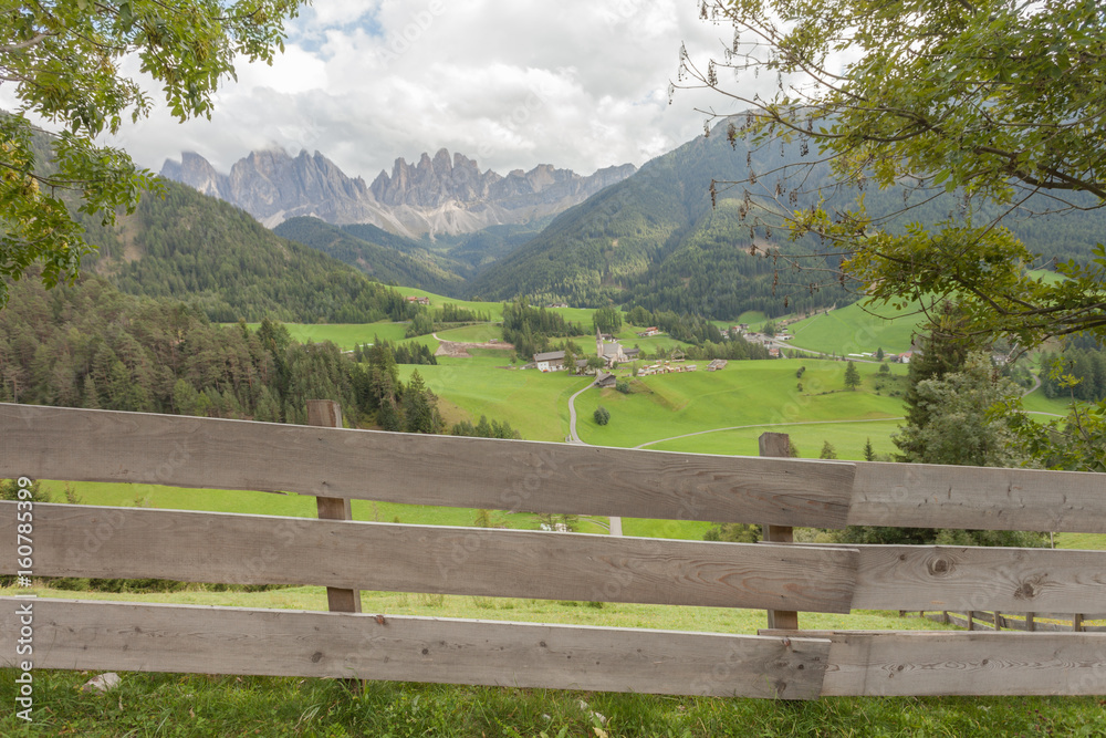 Wooden fence next to  an Italian mountain pasture in St. Magdalena in Val di Funes