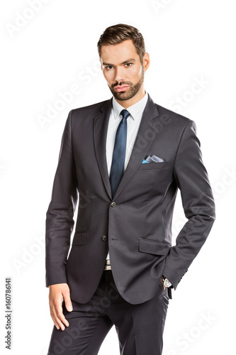 Handsome young businessman standing confident on white background
