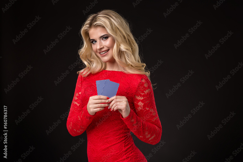 Young beautiful blond woman with playing cards over black. Poker Young beautiful blond woman with playing cards over black. Poker