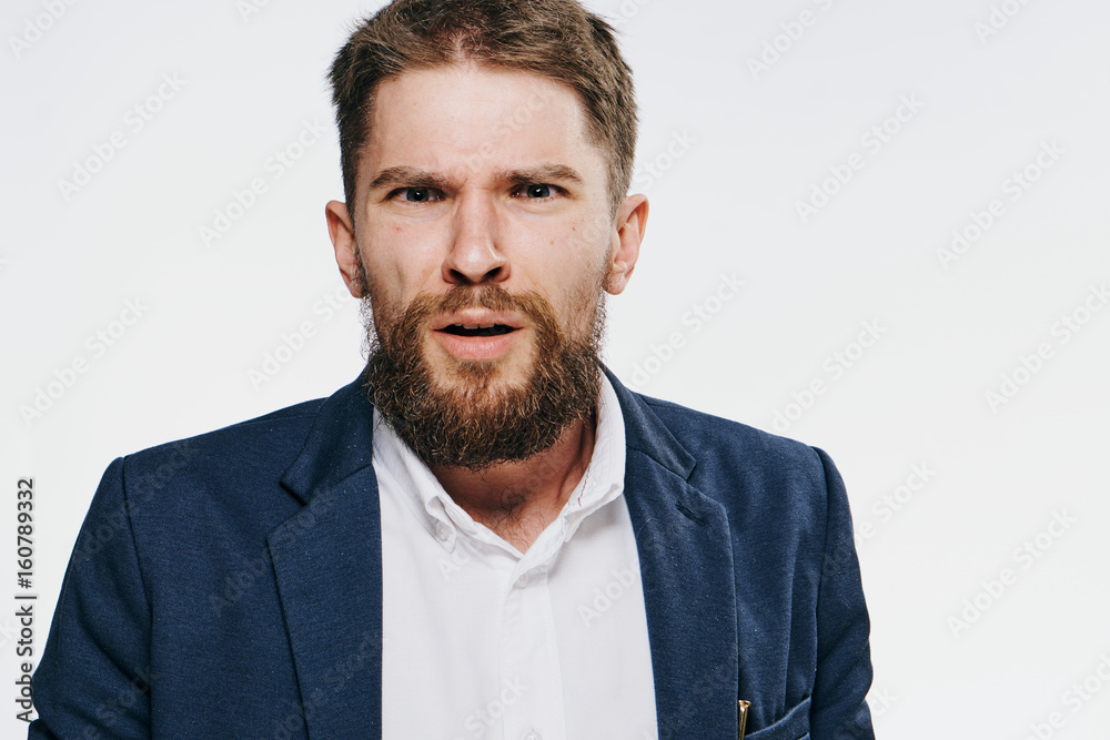 Businessman with a beard, businessman surprised, businessman on a light background Businessman with a beard, businessman surprised, businessman on a light background