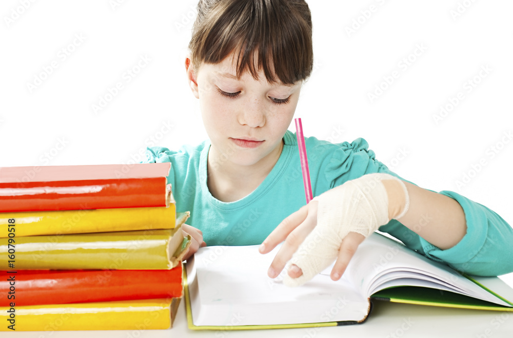 Child with broken hand in classroom, studio shoot. Isolated on white background Child with broken hand in classroom, studio shoot. Isolated on white background