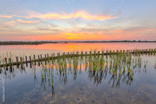 Sunset over lake with lake shore protection