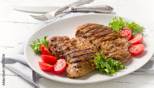 Grilled pork steak and vegetable salad
