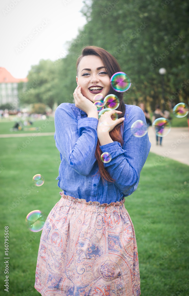 Portrait of a young girl with soap bubbles in the park Portrait of a young girl with soap bubbles in the park