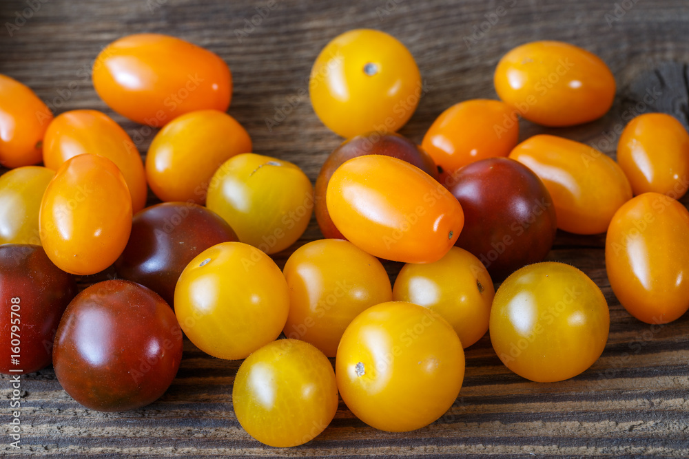 Cherry tomatoes on rustic wooden background Cherry tomatoes on rustic wooden background