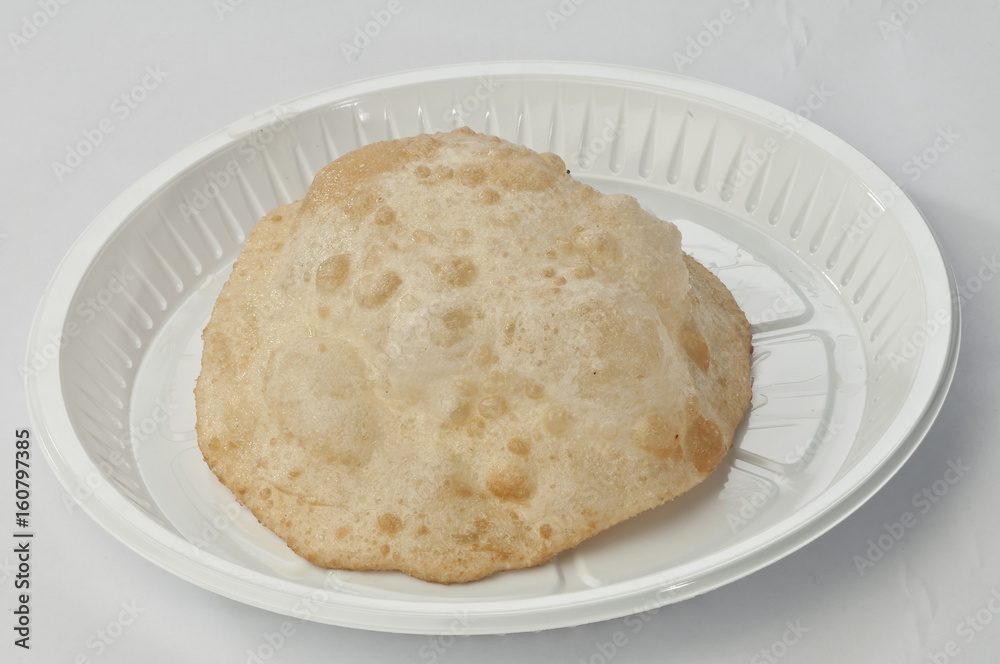 Puri on white disposable plate Puri on white disposable plate