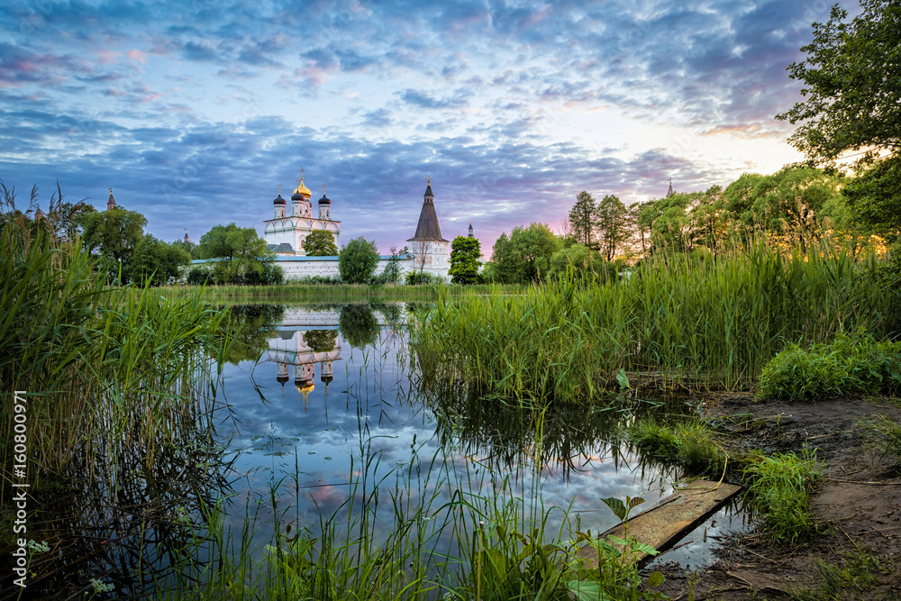 Joseph-Volokolamsk Monastery reflecting in pond on sunset, Moscow oblast, Russia