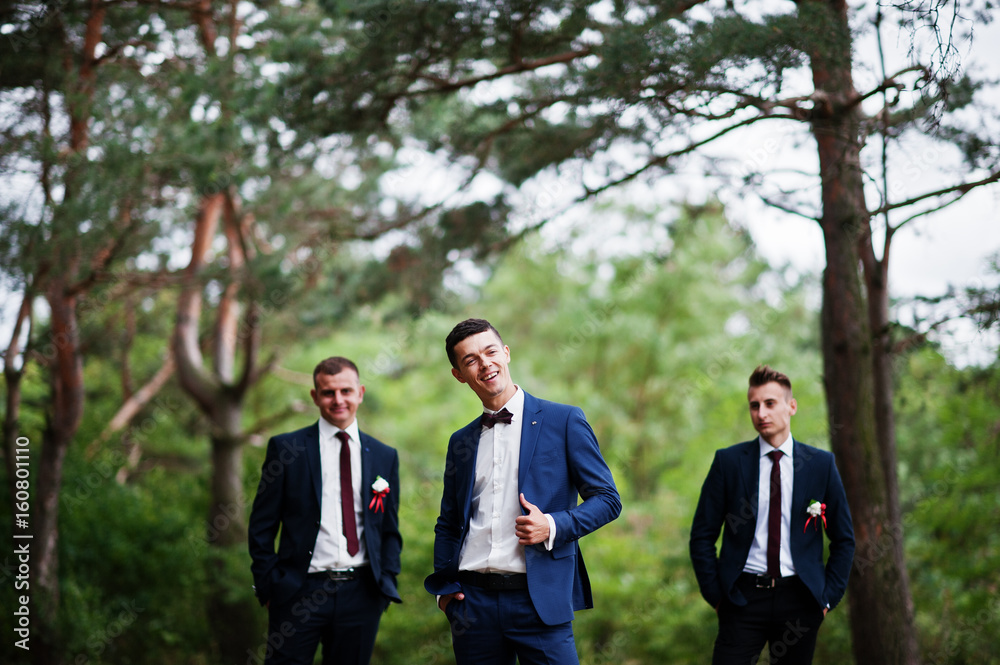 Handsome groom with cool groomsmen walking in the forest and having fun on a wedding day. Handsome groom with cool groomsmen walking in the forest and having fun on a wedding day.