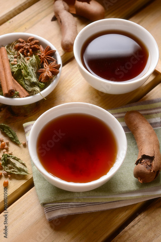 relaxing herbal tea in the bowl with ingredients around