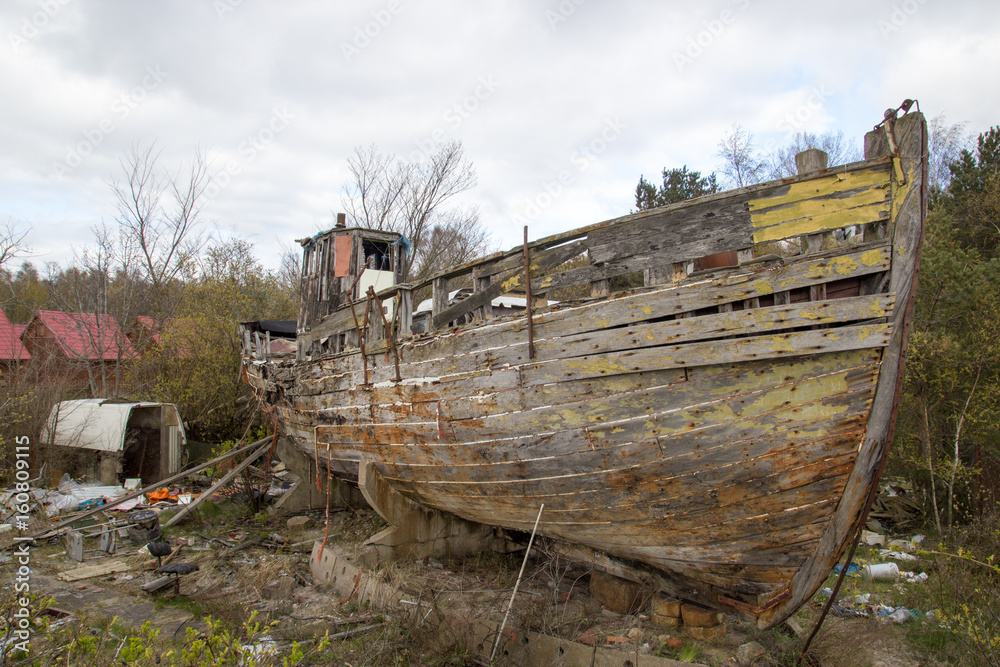 Crumbling wooden boat on the shore
