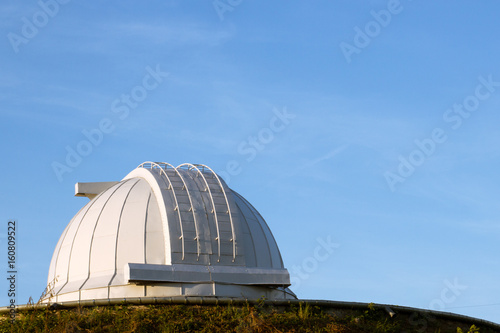 White dome of a large telescope in the Observatory