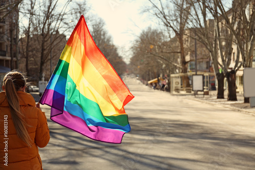 Woman holding gay flag  outdoor