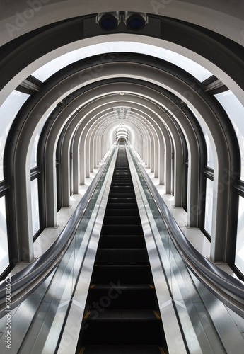 Futuristic tunnel and escalator of steel and metal  interior view. Futuristic background  business concept