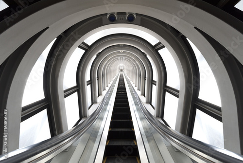 Futuristic tunnel and escalator of steel and metal, interior view. Futuristic background, business concept