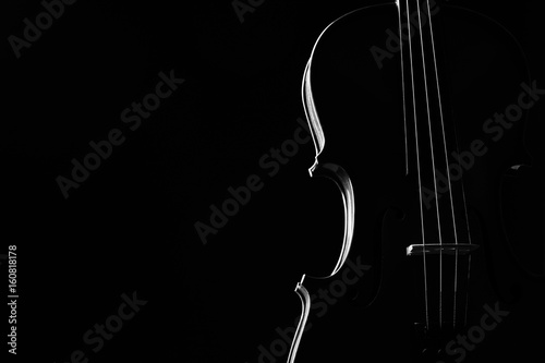 Violin classical music instrument close-up. Stringed musical instrument violin isolated on black background with copy space. Classical orchestra instruments fiddle close up