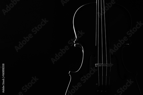 Violin classical music instrument close-up. Stringed musical instrument violin isolated on black background with copy space. Classical orchestra instruments fiddle close up
