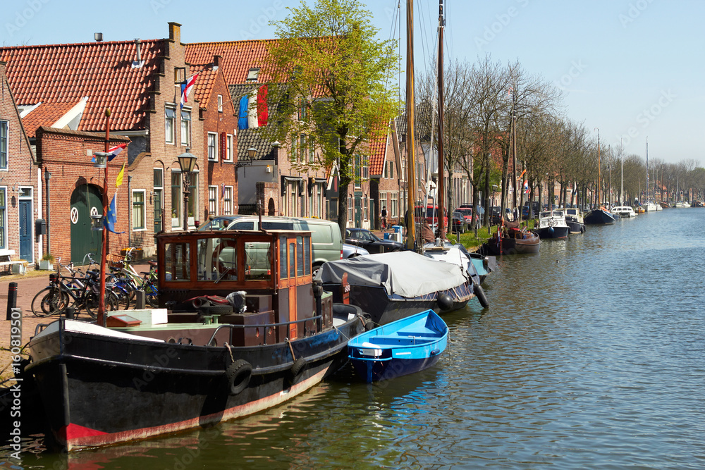 Fototapeta premium Traditional Dutch Botter Fishing Boats in the small Harbor of the Historic Fishing Village in Netherlands.