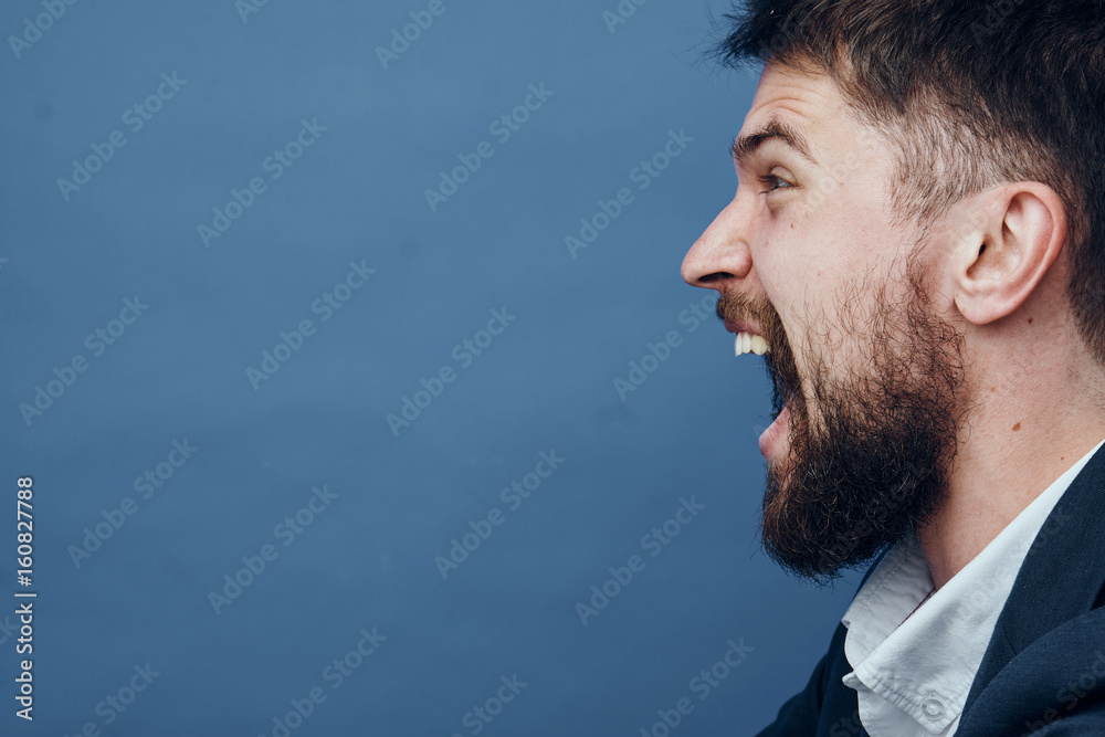 Fototapeta premium Businessman screaming, businessman with a beard, businessman on a blue background