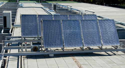 Solar panels over a building roof.
