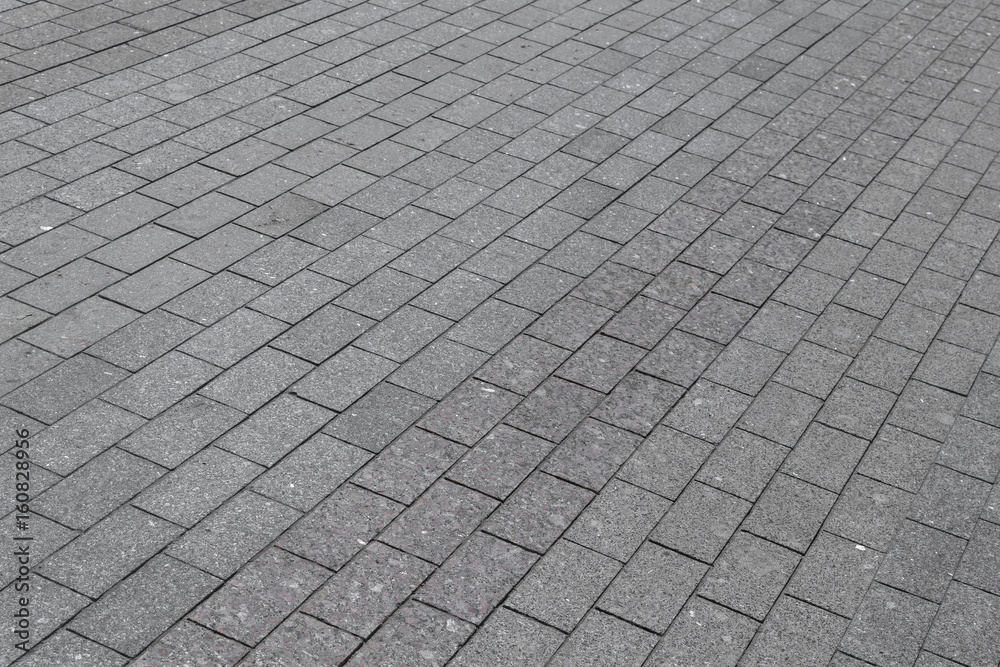 The square or the pavement of granite or marble rectangular tile grey color.