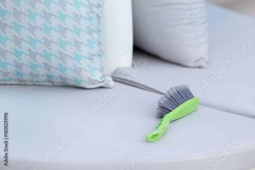 Cleaning brush on outdoor furniture
