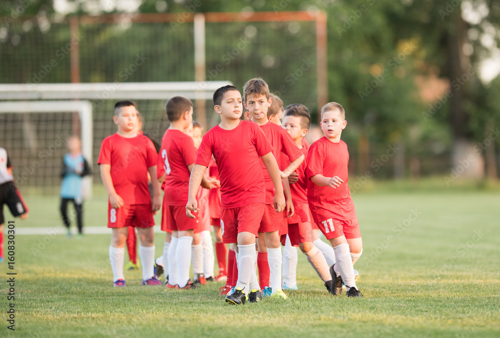 Obraz premium Kids soccer football - children players exercising before match on soccer field