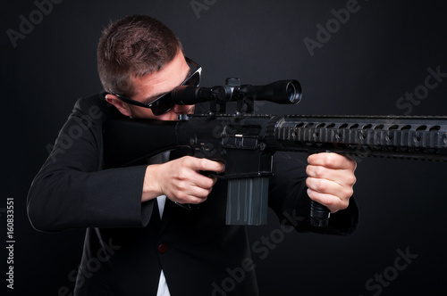 Male killer with sniper rifle