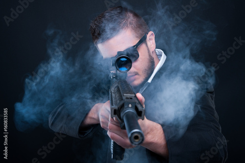 Mafia criminal aiming weapon at you
