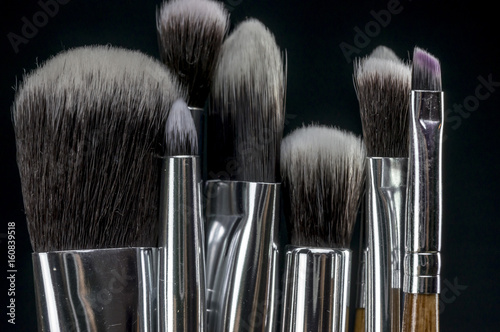 Close up shot of a brush being dipped into eye liner