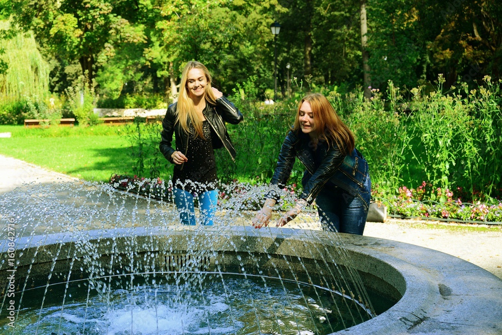 Two girls in Vilnius town Bernardinu garden on autumn