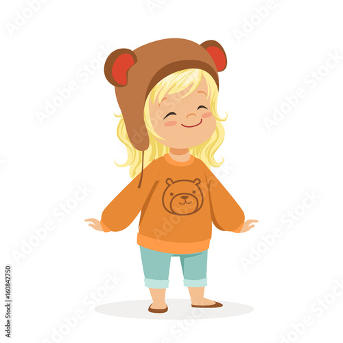 Cute little blonde girl dressed in a brown bear hat and a sweater with teddy bear colorful cartoon character