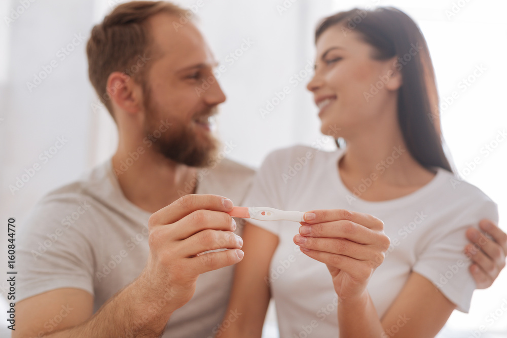 Young couple showing pregnancy test together Young couple showing pregnancy test together