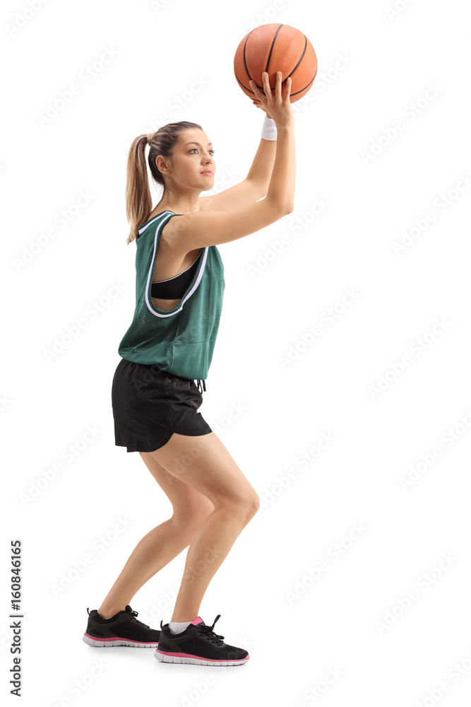 Fototapeta premium Young woman throwing a basketball