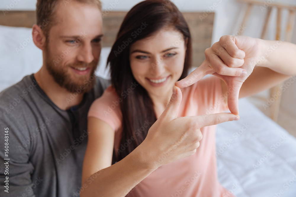 Couple having fun and framing faces with hands Couple having fun and framing faces with hands