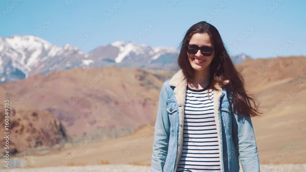 Beautiful girl on nature smiling and laughing. Against the background of the mountain Beautiful girl on nature smiling and laughing. Against the background of the mountain
