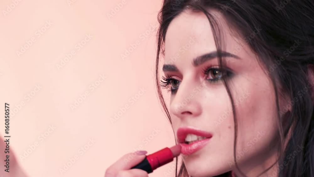 Beautiful female lips with make-up and brush Beautiful female lips with make-up and brush
