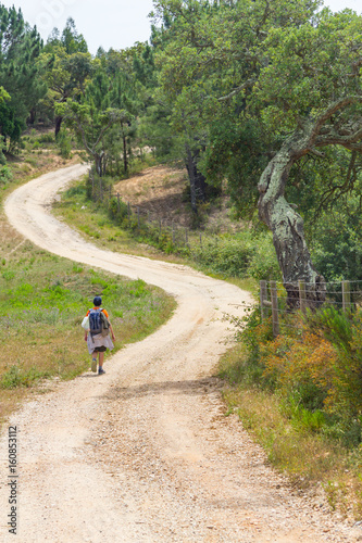 Girl hiking in a Trail in Cork tree forest Santiago do Cacem