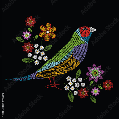 Vector illustration embroidery stitches with gouldian finch, chamomile wildflowers, spring flowers, branches in color. Fashion ornament on black background for textile and fabric.