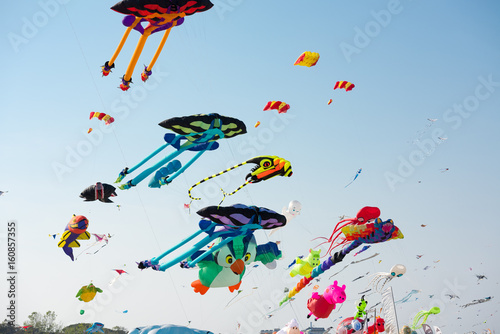 Colorful kites flying in the sky photo