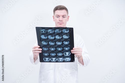 caucasian doctor holding ct scan film 