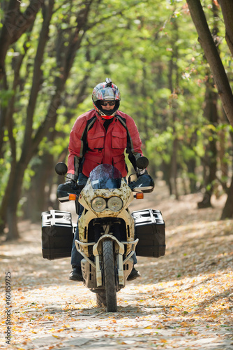 Motorcycle rider in forest