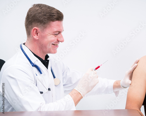 caucasian doctor in protect gloves making patient injection