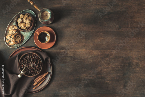 top view of coffee with beans and brown sugar with cookies on wooden tabletop