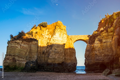 The Praia da Batata bridge at sunset in Lagos, Portugal photo