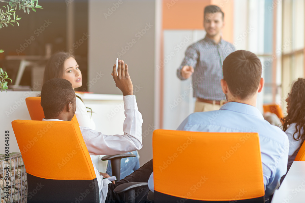 business, startup, presentation, strategy and people concept - man on presentation with group of people at office business, startup, presentation, strategy and people concept - man on presentation with group of people at office