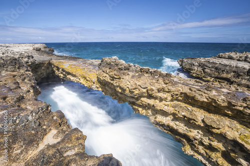 Waves in the natural arches of limestone carved by sea Devil's Bridge Caribbean Antigua and Barbuda Leeward Islands West Indies