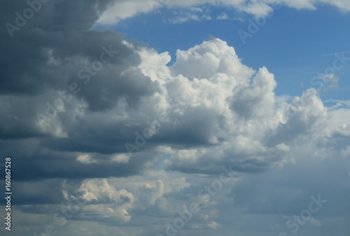 Fototapeta Naklejka Na Ścianę i Meble -  Quaint clouds in the sky. Clouds before the rain and after. The play of light and shadow