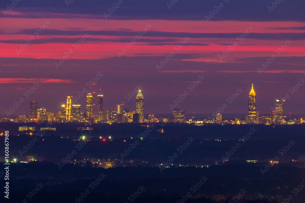 The beautiful view of illuminated Midtown Atlanta from the Stone Mountain at twilight with red sky, Georgia, USA