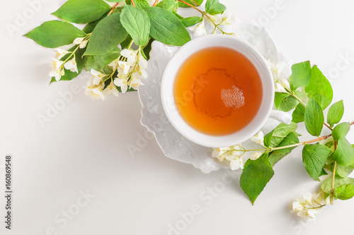 Wallpaper Mural Cup of tea with jasmine flowers on a white table Torontodigital.ca